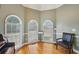 Bright music room with hardwood floors, chair rail, and three large arched windows at 4740 Arbor Meadows Dr, Cumming, GA 30040