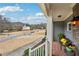 Inviting porch with stone accents, comfortable seating, and a charming view of the quiet neighborhood street at 4740 Arbor Meadows Dr, Cumming, GA 30040