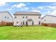 Spacious backyard with lush green grass and a patio seating area at 4758 Sultana Way, Atlanta, GA 30331