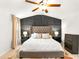Bedroom with neutral tones, a ceiling fan, and a nicely decorated accent wall at 4758 Sultana Way, Atlanta, GA 30331