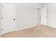 Neutral bedroom featuring an open white door leading to another room and carpet flooring at 4758 Sultana Way, Atlanta, GA 30331