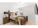 Comfortable bedroom with wood furnishings, plush bedding, and neutral decor at 4758 Sultana Way, Atlanta, GA 30331