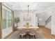 Elegant dining room with coffered ceiling, modern chandelier, and a table set for four at 4758 Sultana Way, Atlanta, GA 30331