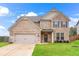 Charming two-story brick home with a well-manicured lawn and an attached two-car garage in a suburban setting at 4758 Sultana Way, Atlanta, GA 30331