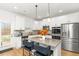 Modern kitchen boasts stainless steel appliances, quartz countertops, and a spacious island with bar seating at 4758 Sultana Way, Atlanta, GA 30331