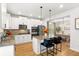 Bright kitchen with white cabinets, stainless appliances, island, and adjacent dining area at 4758 Sultana Way, Atlanta, GA 30331