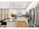 Stylish kitchen featuring white cabinetry, stainless steel appliances, and a large island with pendant lighting at 4758 Sultana Way, Atlanta, GA 30331