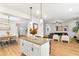 Open concept living area, featuring a dining room, kitchen island, and a comfortable seating arrangement at 4758 Sultana Way, Atlanta, GA 30331