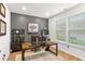 Comfortable home office featuring a large desk, dual monitors, and ample natural light from the window at 4758 Sultana Way, Atlanta, GA 30331
