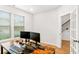 Bright home office with a desk, dual monitors, and a view out the window, plus a glimpse into the hallway at 4758 Sultana Way, Atlanta, GA 30331