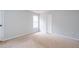Bedroom with light walls, carpeted floor, and window providing natural light at 218 Pine Needle Trl, Villa Rica, GA 30180