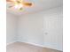 Bedroom with neutral carpet, closet, and a ceiling fan at 218 Pine Needle Trl, Villa Rica, GA 30180