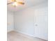 Bedroom with neutral carpet, closet, and a ceiling fan at 218 Pine Needle Trl, Villa Rica, GA 30180
