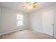 Bedroom with neutral carpet, a window for natural light, and a practical closet at 218 Pine Needle Trl, Villa Rica, GA 30180