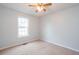 Comfortable bedroom featuring soft neutral carpet, a ceiling fan, and window for natural light at 218 Pine Needle Trl, Villa Rica, GA 30180