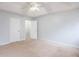 Bedroom with neutral carpet, a ceiling fan, and a convenient walk-in closet at 218 Pine Needle Trl, Villa Rica, GA 30180