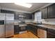 Modern kitchen with stainless steel appliances, sleek countertops, and plenty of cabinet space for storage at 218 Pine Needle Trl, Villa Rica, GA 30180
