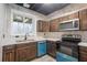 An eat-in kitchen with modern appliances, wood cabinets and a large window at 218 Pine Needle Trl, Villa Rica, GA 30180