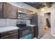 The kitchen has stainless appliances, tile backsplash, and stained wood cabinets at 218 Pine Needle Trl, Villa Rica, GA 30180