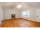 Bright living room features hardwood floors, stone fireplace and large windows at 218 Pine Needle Trl, Villa Rica, GA 30180