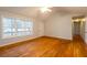 Open living space with hardwood floors, a ceiling fan, and bright windows at 218 Pine Needle Trl, Villa Rica, GA 30180