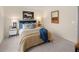 Cozy bedroom featuring carpet flooring, an upholstered headboard, and matching bedside tables with lamps at 2201 Cormac St, East Point, GA 30344