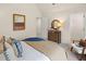 Bright bedroom features a neutral color scheme, vaulted ceilings, carpet flooring, and a decorative mirror at 2201 Cormac St, East Point, GA 30344