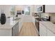 Modern kitchen featuring stainless steel appliances, granite countertops, and white cabinetry at 2201 Cormac St, East Point, GA 30344