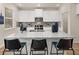 Modern kitchen showcasing a large granite island, stainless steel appliances, and ample cabinet space at 2201 Cormac St, East Point, GA 30344
