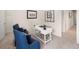 Home office area featuring a white desk and comfortable blue armchairs at 2201 Cormac St, East Point, GA 30344