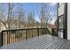 A spacious back deck with stained wood overlooking a wooded backyard and neighboring houses at 4340 Boxwood Trl, Ellenwood, GA 30294