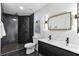 Elegant bathroom features a double sink vanity, herringbone tile shower and modern gold fixtures at 4340 Boxwood Trl, Ellenwood, GA 30294