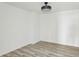 A minimalist bedroom with gray wood floors and a modern ceiling light at 4340 Boxwood Trl, Ellenwood, GA 30294