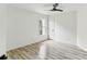 Well lit bedroom featuring light wood floors, a modern ceiling fan, and a bright window at 4340 Boxwood Trl, Ellenwood, GA 30294