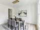 Elegant dining room featuring modern lighting, decor, a large window and a dining table set for six at 4340 Boxwood Trl, Ellenwood, GA 30294