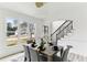 Bright dining area featuring a window view, a modern chandelier, and seamlessly flowing into the home's open layout at 4340 Boxwood Trl, Ellenwood, GA 30294