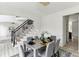 Tastefully designed dining room featuring a view of the staircase, modern lighting, and seating for six around a wooden table at 4340 Boxwood Trl, Ellenwood, GA 30294