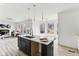 A modern kitchen featuring white cabinets, a black tile backsplash, quartz countertops and a center island with bar stool seating at 4340 Boxwood Trl, Ellenwood, GA 30294