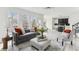 Stylish living area featuring wood floors, modern furnishings, and an open layout leading to a well-equipped kitchen at 4340 Boxwood Trl, Ellenwood, GA 30294