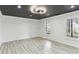 Bright living room with modern lighting, light wood floors, and a view of the outdoors at 4340 Boxwood Trl, Ellenwood, GA 30294