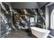 Bathroom shower and bathtub featuring black tile, gold fixtures and a window view at 4340 Boxwood Trl, Ellenwood, GA 30294