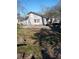 The backyard has a concrete slab, some grass and ground cover, and a view of a house at 550 Lake Dr, Hapeville, GA 30354