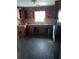 A kitchen with rustic wood cabinets, a sink under the window, and a black refrigerator to the side at 550 Lake Dr, Hapeville, GA 30354