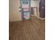 A room featuring wood-look flooring, a colorful door and a large mirror leaning against the wall at 550 Lake Dr, Hapeville, GA 30354