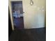 An interior view of a room featuring yellow walls, dark flooring and a view into another room at 550 Lake Dr, Hapeville, GA 30354