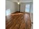Bright bedroom with laminate floors, ceiling fan, and a window offering natural light at 1173 Mill Ridge Dr, Lawrenceville, GA 30045