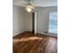Bright bedroom featuring hardwood floor, fan, and a window with blinds at 1173 Mill Ridge Dr, Lawrenceville, GA 30045