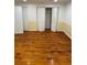 Spacious room with wood floors, yellow lower walls, and multiple closet doors at 1173 Mill Ridge Dr, Lawrenceville, GA 30045