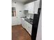 Functional kitchen features white cabinets and appliances, and laminate flooring at 1173 Mill Ridge Dr, Lawrenceville, GA 30045