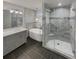 Modern bathroom with a walk-in shower, separate tub, gray vanity and gray tile accents at 2548 Loghaven Nw Dr, Atlanta, GA 30318
